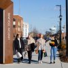 Four women walking on City Walk with shopping bags