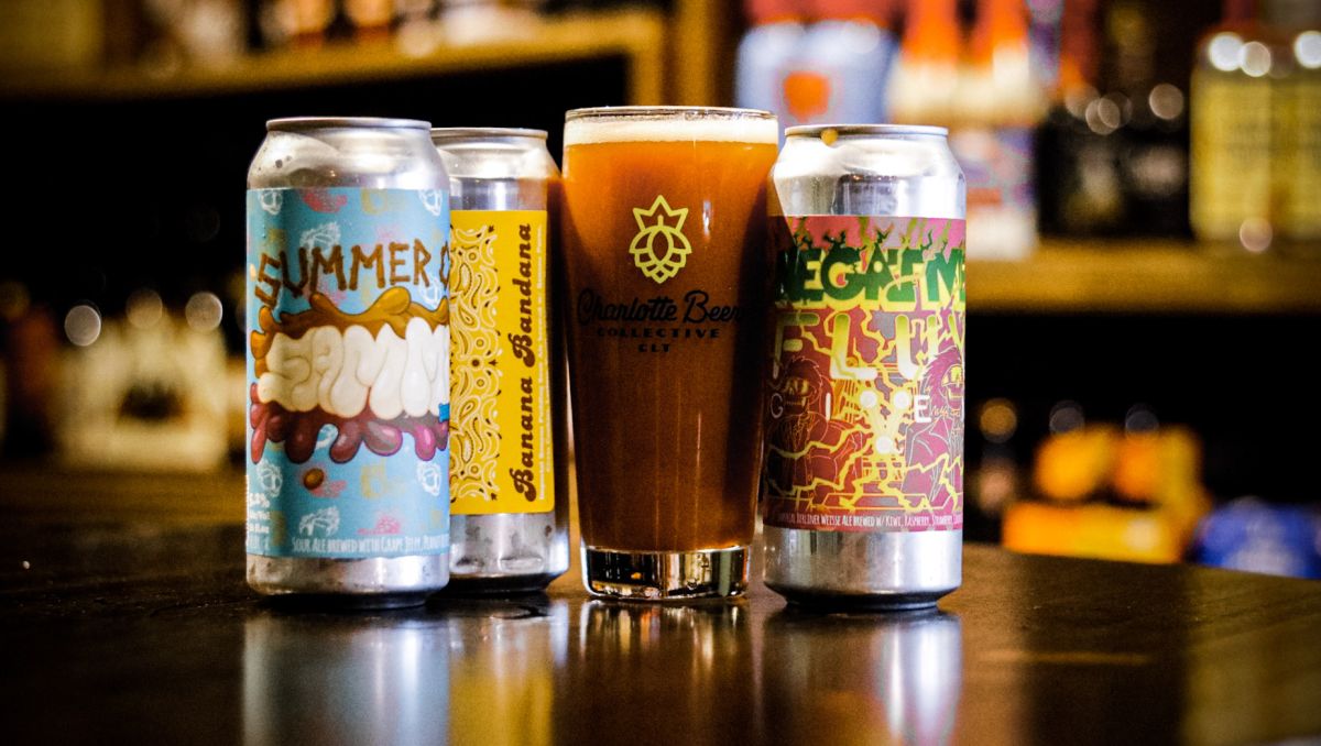 Three cans of beer and one pint on display on table