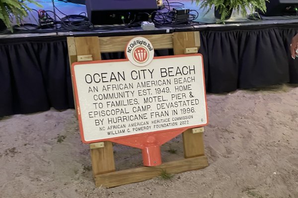 Sign depicting part of the NC Civil Rights Trail in front of stage