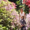 Mother and daughter smiling in middle of blooming plants