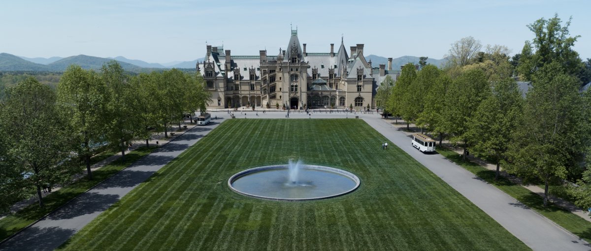 Vast, empty grounds of Biltmore with estate and mountains in back