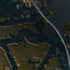 Aerial of coastal forest with bogs, marshes and a walkway over water