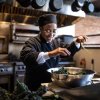 Chef in restaurant kitchen cooking collards