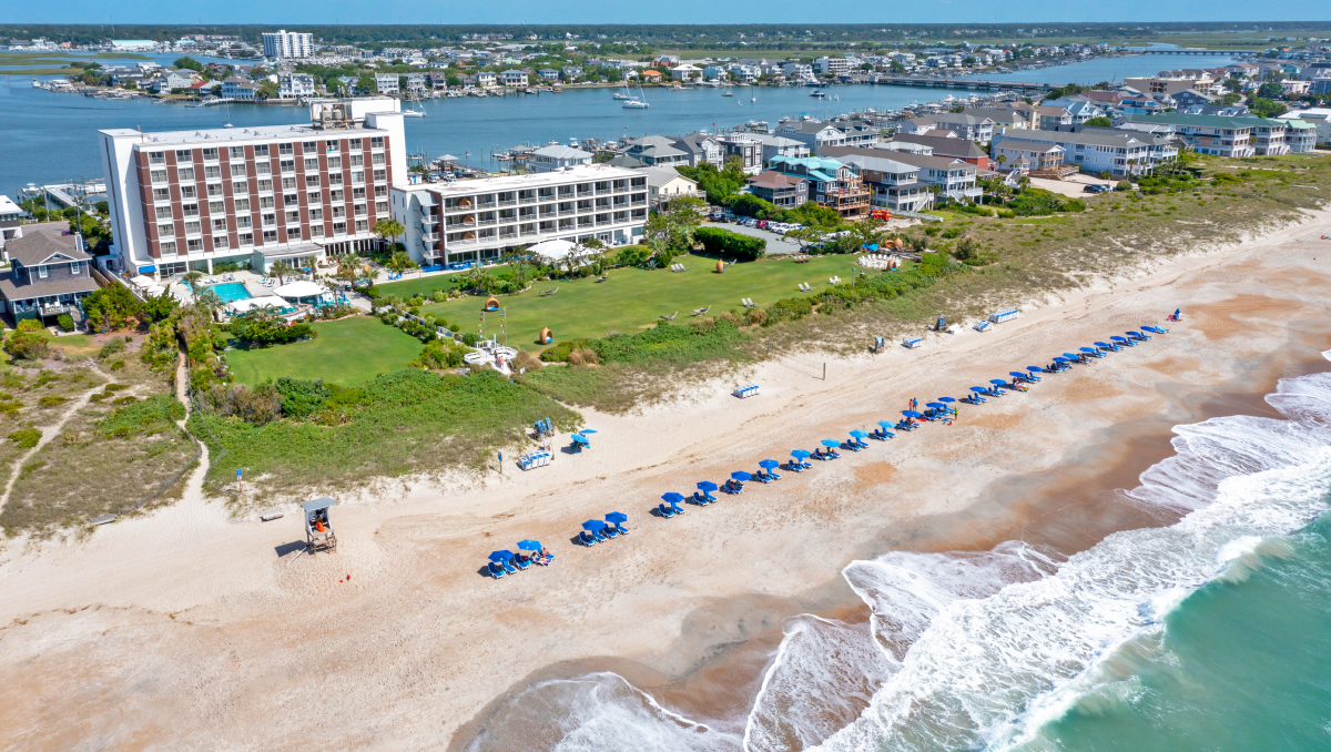 Aerial of resort's beach, beach chairs, gardens and sound