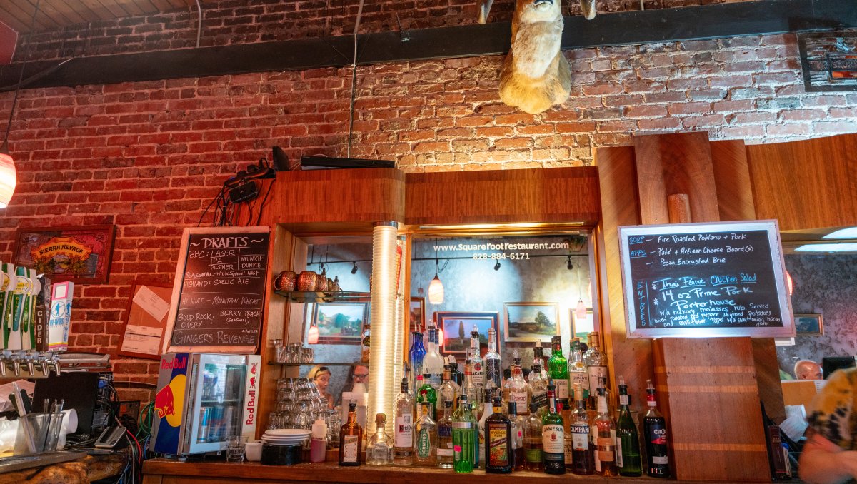 Back of bar with brick wall in background at Square Root Restaurant.