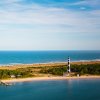 Aerial view of lighthouse, national seashore and water on both sides of land during daytime