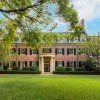 Exterior of brick Carolina Inn with charming courtyard in foreground