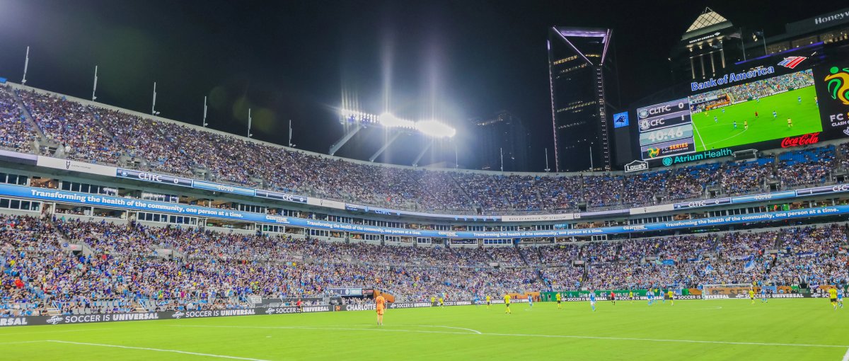 Field level at Charlotte FC match with full stands and skyline in background