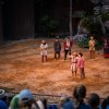 Actors on stage of "Unto These Hills" outdoor drama with patrons in audience