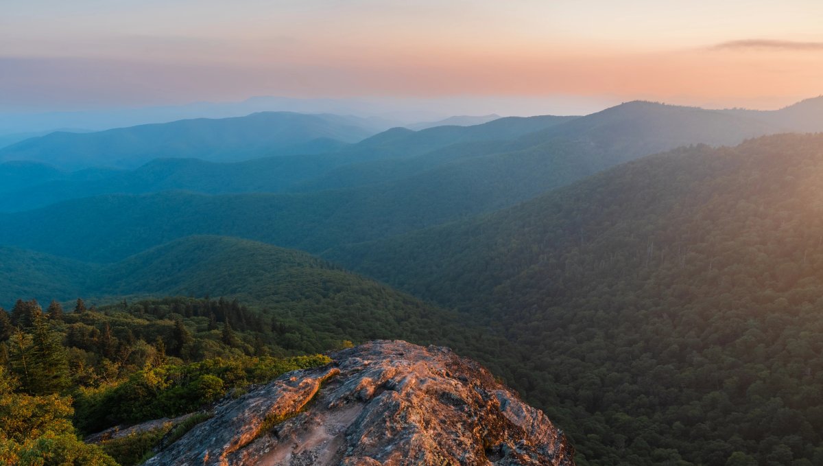 Long-range Blue Ridge Mountain views overlook under hazy orange sky