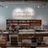 Counter of chocolate shop with sign above it reading "Crafted with love and served with gratitude"