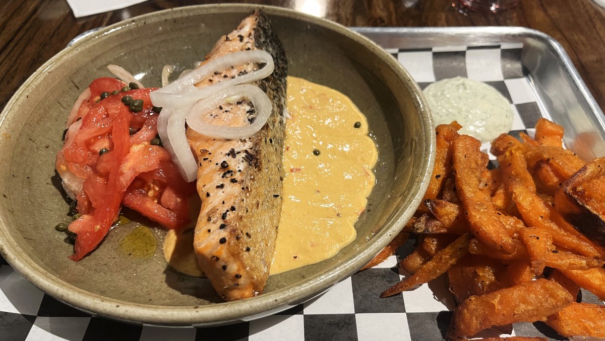 Plate of salmon, veggie and sweet potato fries on the side