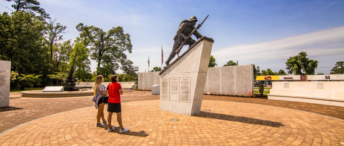 Two people observing memorial in outdoor gardens