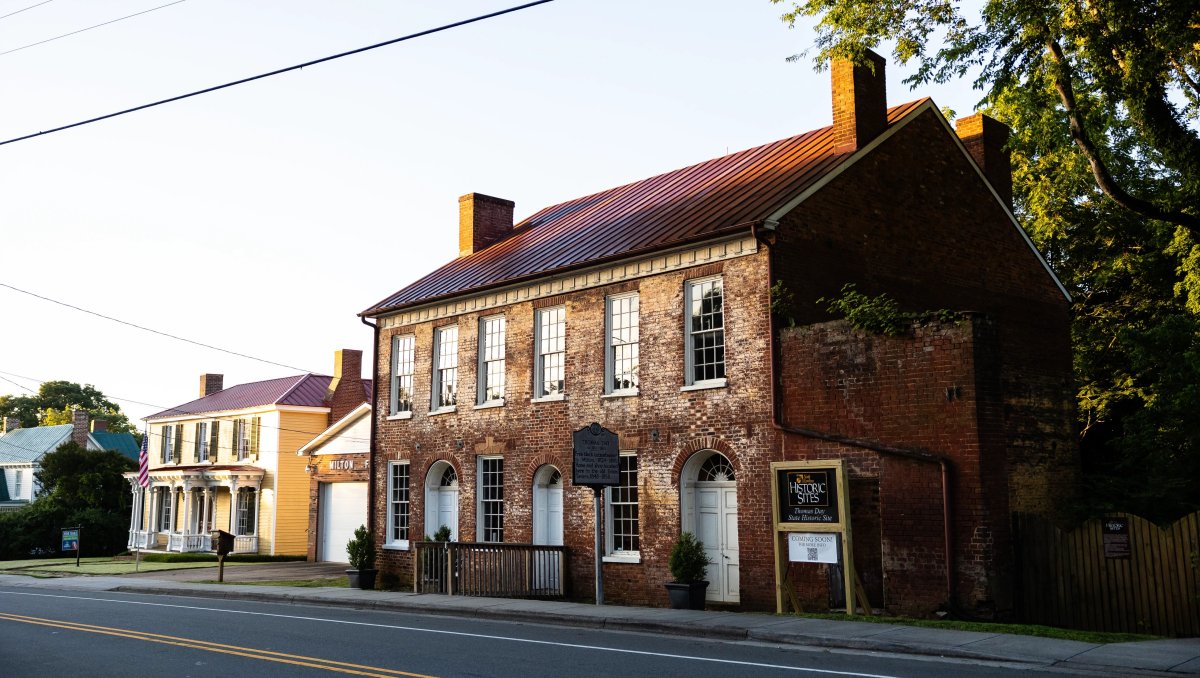 Exterior of brick Thomas Day House with Historic Site sign out front