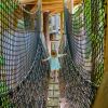 Little girl walking on rope bridge at Museum of Life and Science's Treehouse Village in Durham