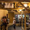 Woman looking at Blackbeard pirate replica inside maritime museum exhibit