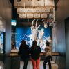 Group of friends looking at basketball exhibit at NC Sports Hall of Fame 