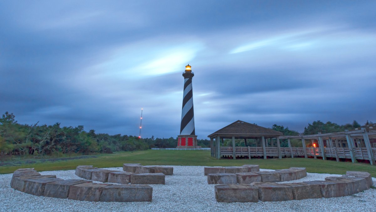 Long-range view of Cape Hatteras Lighthouse and grounds at dusk