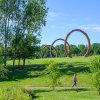 Woman walking on path in the outdoor Museum Park at North Carolina Museum of Art on sunny day