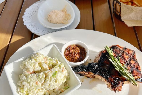 Plates of food and sides on table at dinnertime