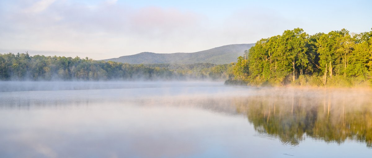 Price Lake with mist over water and trees and mountains in background