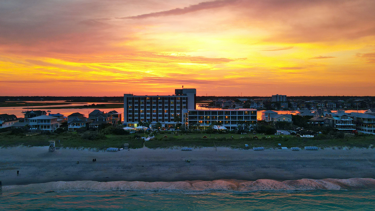 Sun setting over sound behind beach resort