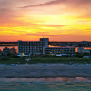 Sun setting over sound behind beach resort