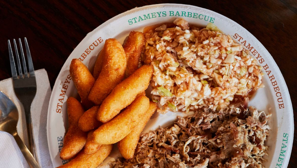 Plate of barbecue and sides with Stamey's Barbecue written on plate