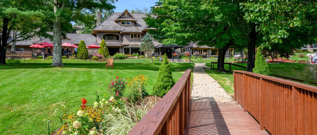 Foot bridge leading to green lawn, restaurant and mountain resort