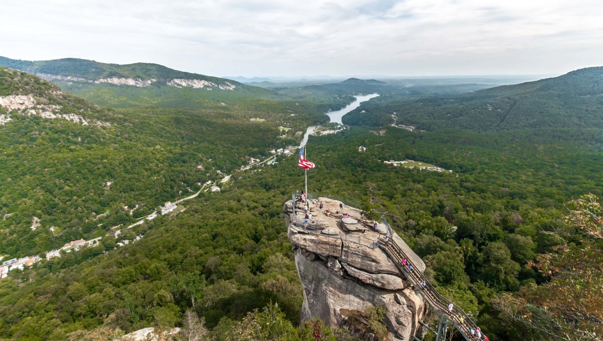 Distant view of Chimney Rock peak with green valley and river in distance