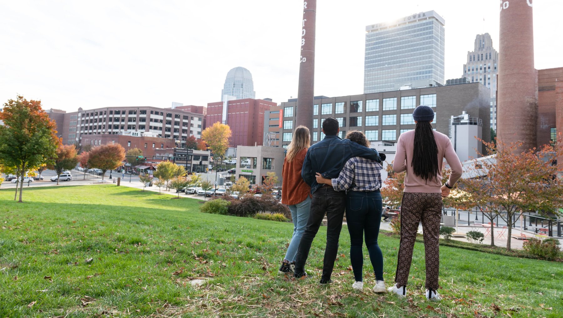 A group of people standing in a grassy field