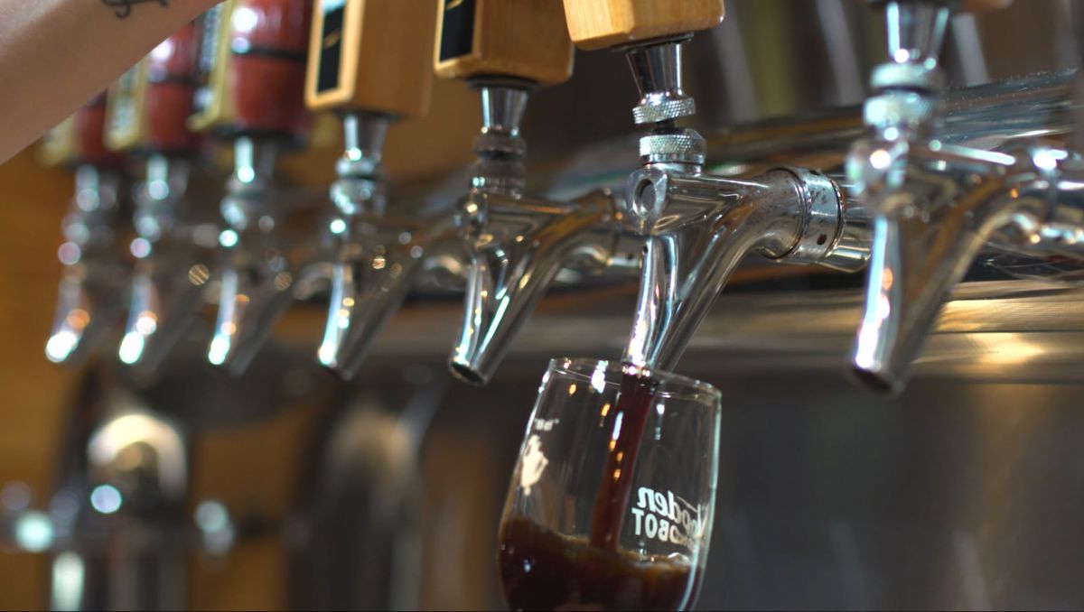 Dark beer on tap from Wooden Robot being poured into glass